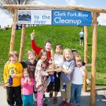 2015 Clark Fork River Cleanup - kids under CFC sign - Photo by Robin Carleton